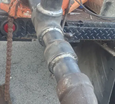 This image shows another professional weld that holds together very large, heavy metal pipes.