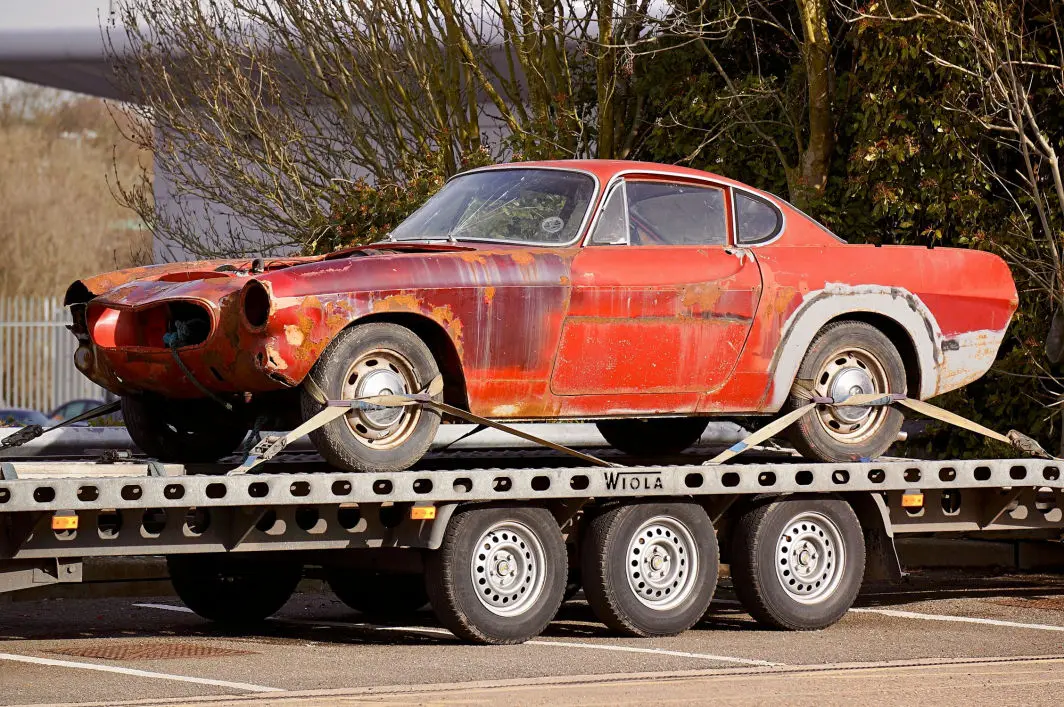 This image shows a trailer pulling a car that needs the talent of Branson Welding and Fabrication professional, certified welders.